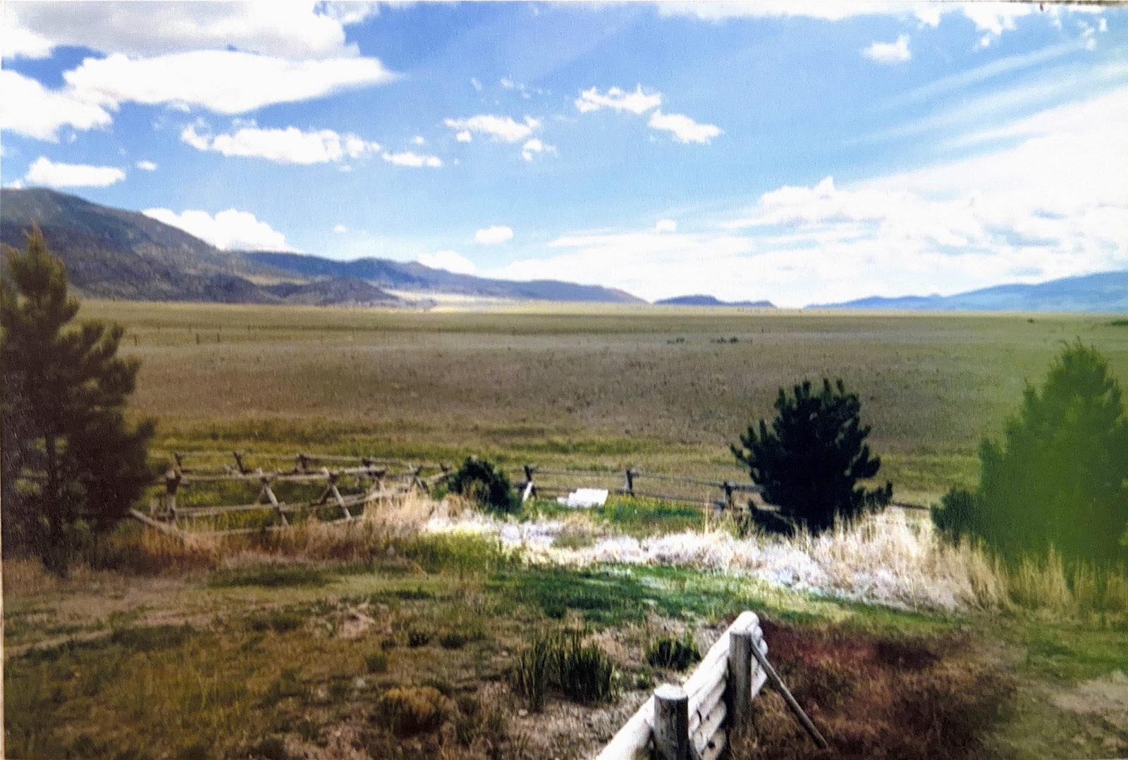 The valley and mountains past the fence line.