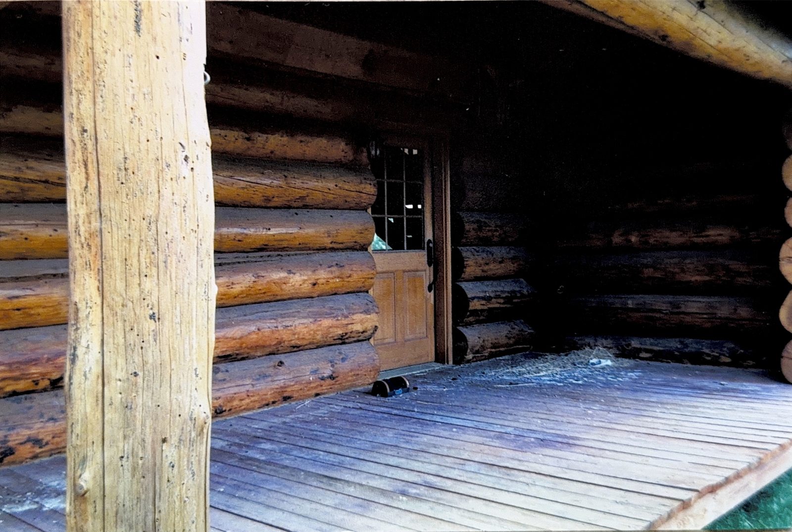 Bare porch decking and rough-cut posts.
