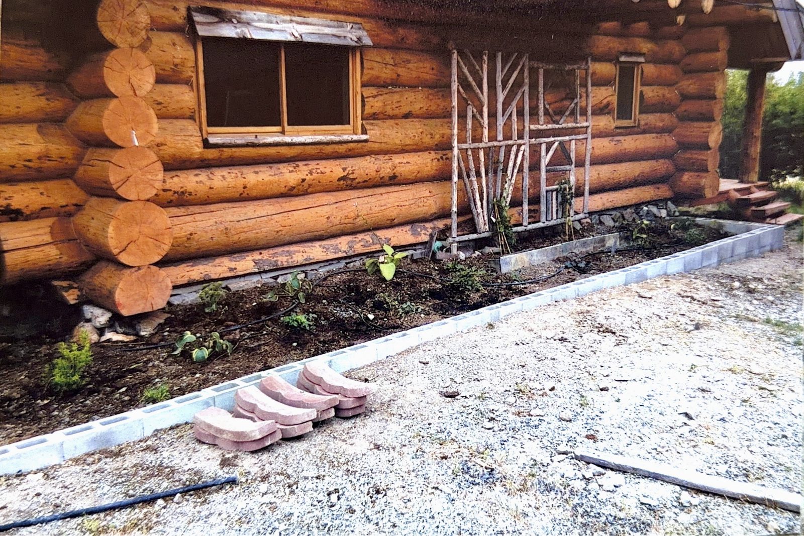 Gravel and the first plantings along the cabin wall.