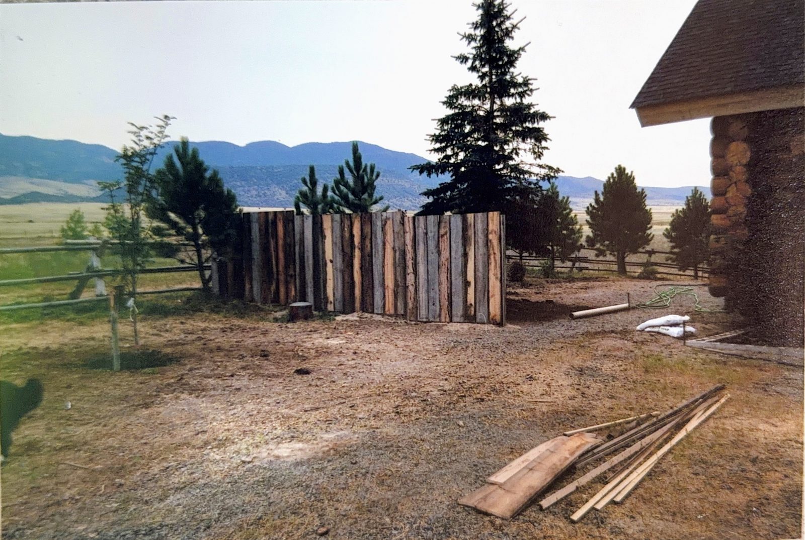 A new fence panel and a bare, cleared yard.