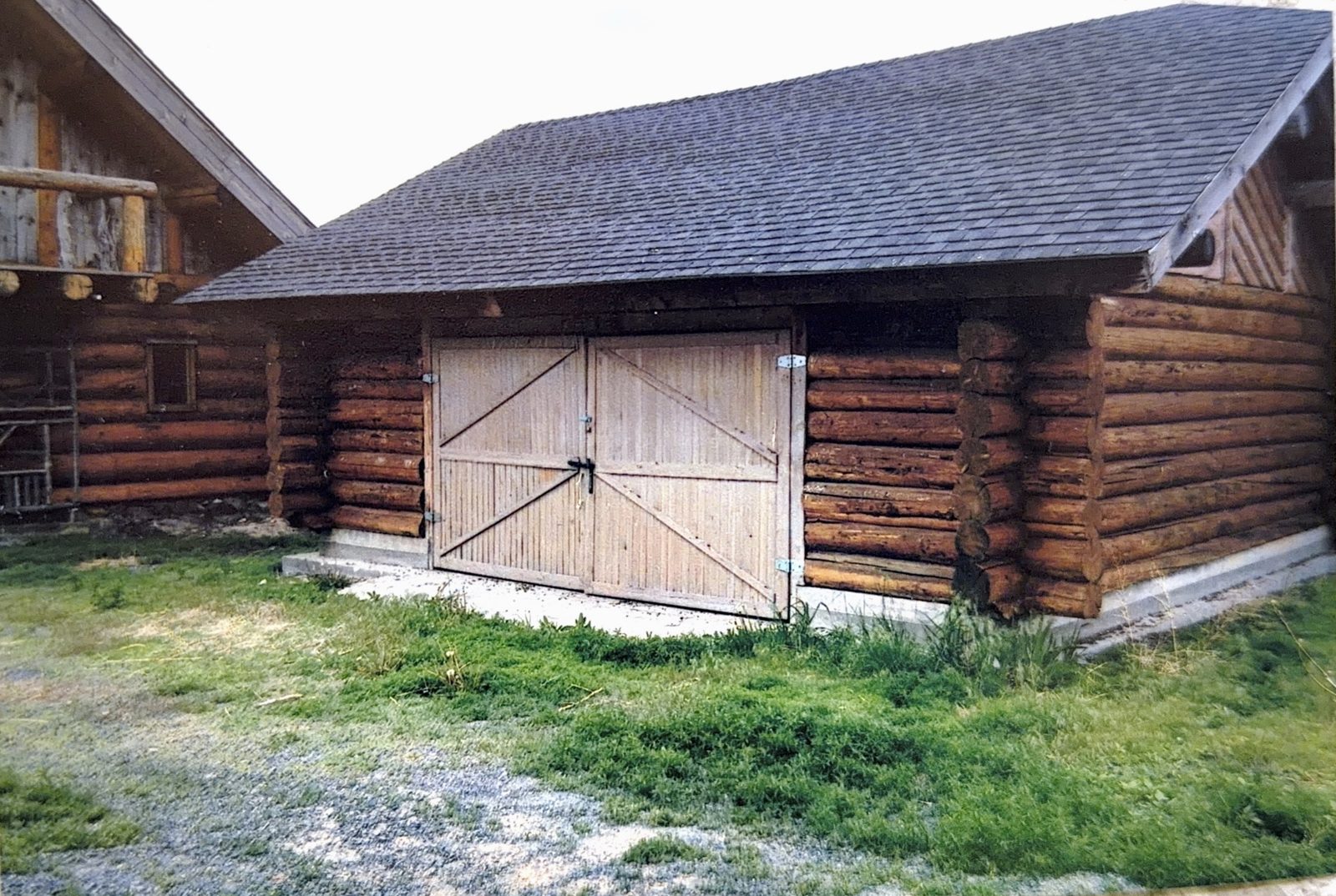 The log barn with its timber doors.